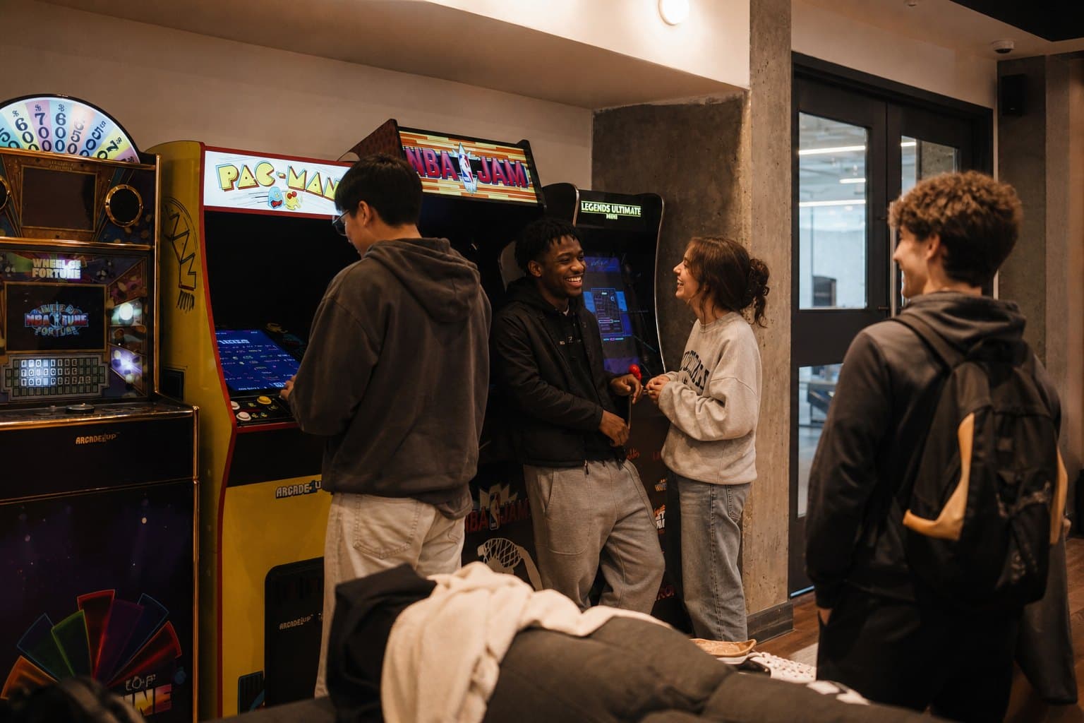 Friends at the arcade in the ALMA ByWard Market games room
