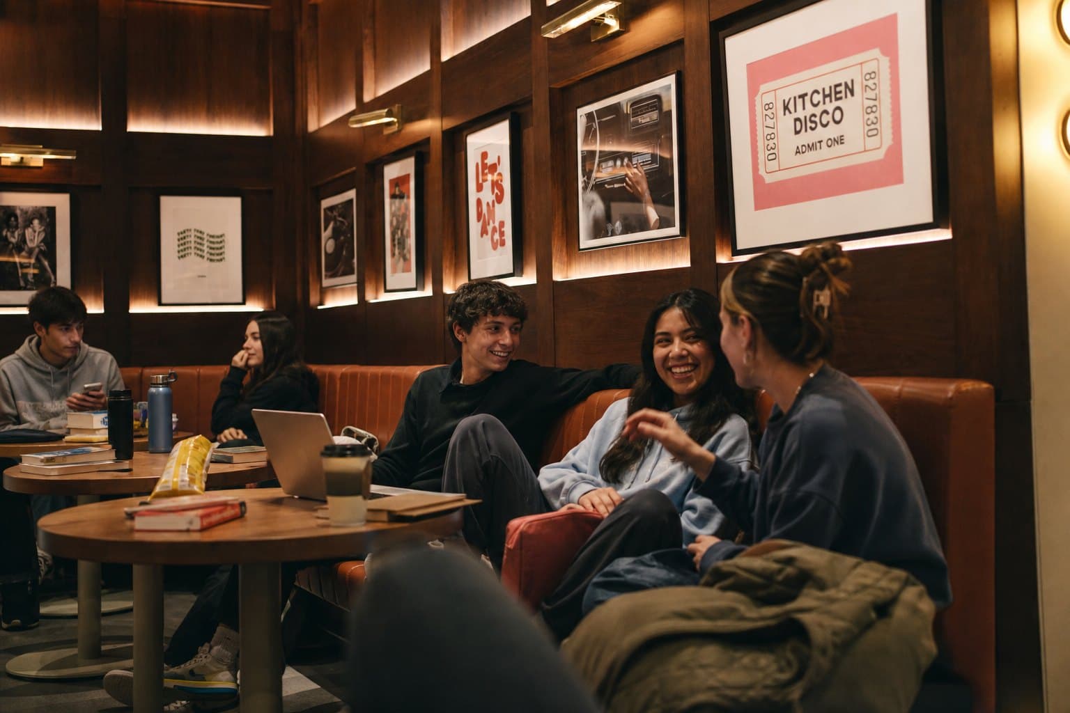 Residents laughing on the banquette at The Collective, ALMA ByWard Market