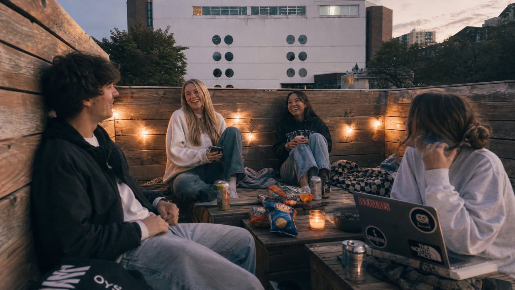 Rooftop patio under string lights at night