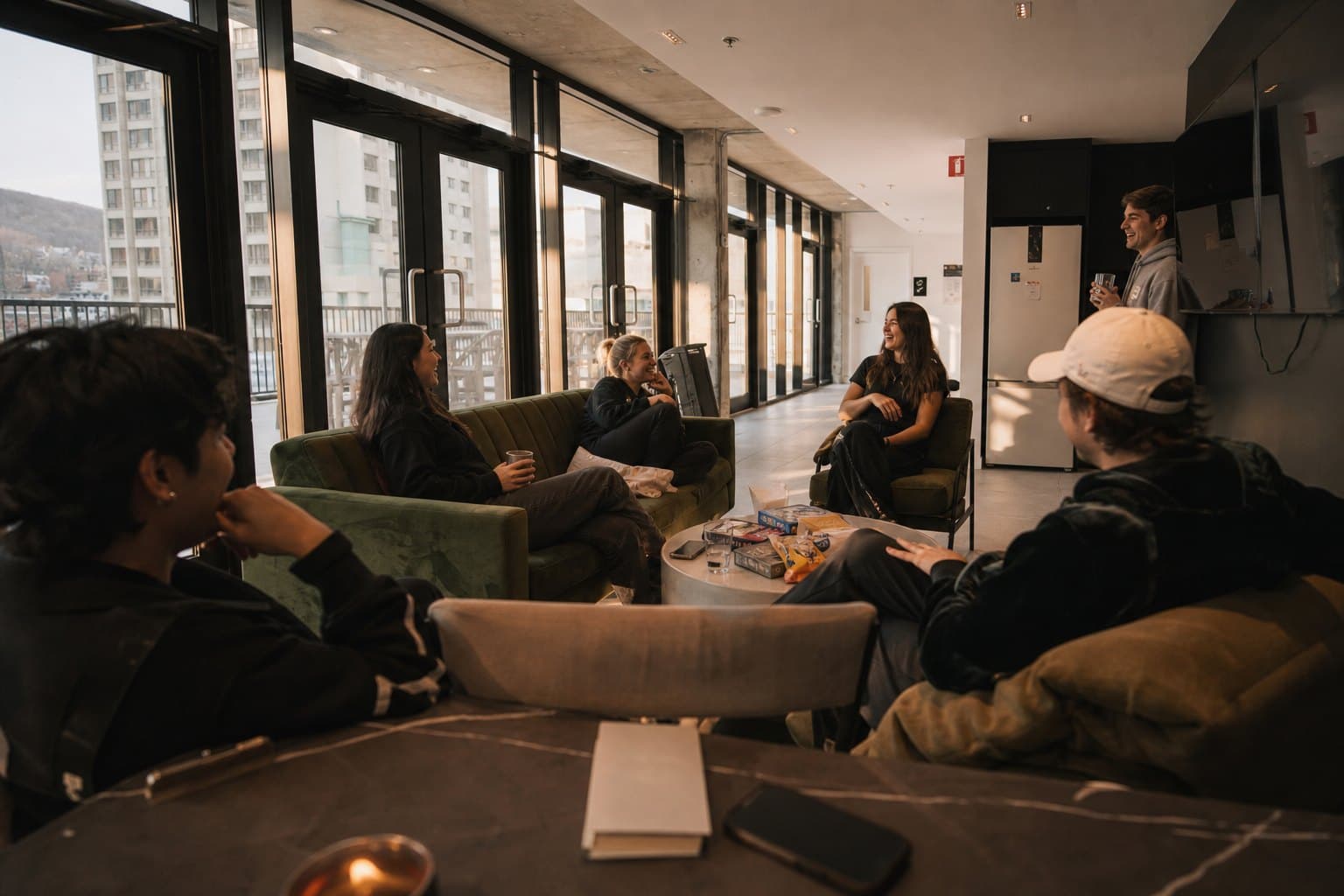 Residents on the ALMA Shaughnessy Village lounge sofas at golden hour