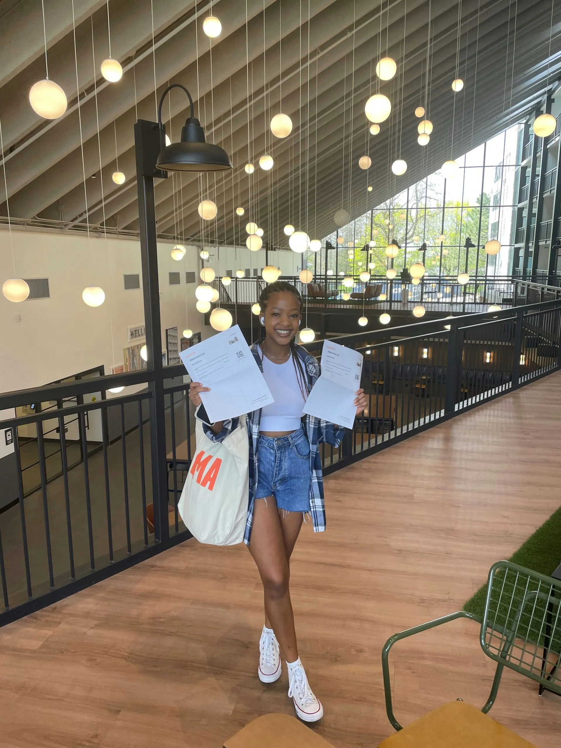 Girl holding two pieces of paper